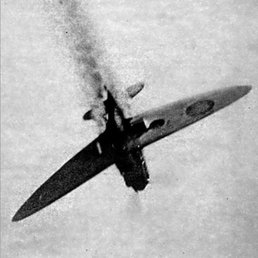 Spitfire shot down, trailing smoke as it falls.