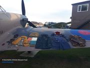Uniform, flying kit, logbook, medals and other personal items of Sgt Eric Adams laid out on the wing of the Museum’s Hurricane
