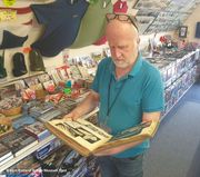 Sir Sydney Camm&rsquo;s photographic album being looked through in the Museum shop