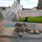 Fire-damaged goggles, oxygen mask, parachute pull ring and flying log books of F/O Peter Davies on the wing of the Museum’s Hurricane