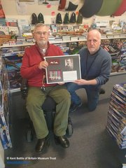 Framed medals, pilot’s wings and photograph of F/O Michael Homer being handed over to the Museum