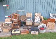 1940s living room and kitchen items donated by the Old Forge War Time House, laid out beside a Museum hangar