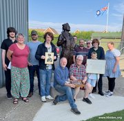 Air Commodore Philip J. Sanders' family with his medals, photograph and commission at the Museum