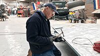 Robbie applying his 50 years of panel beating skills to repair a section of the port wing.
