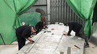 Charles, Dave and Julian, preparing port wing for eixing on new panel strips.