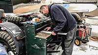 Julian, guillotining to size a new wing panel strip.