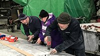 The rivet team - Charles, Suz and Dave - fixing new wing panel strips to the wing.