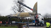 Lifting carefully over the museum compound fence.