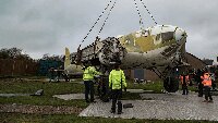 Final lift of the fuselage onto its concrete base.