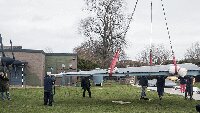 Moving port wing into position.