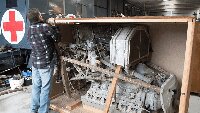 Ed Hawkes, removing the wooden crate around the engine.