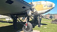 Museum volunteers preparing the fuselage underside for painting.