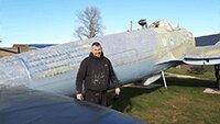 Museum volunteer Julian, having completed spraying the blue underside of the fuselage.