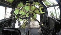 Looking forward in the cockpit, pilot seat on left hand side.