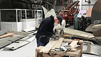 Robbie sanding down panel in preparation for spraying.