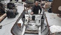 Brad Day preparing one of the engine cowlings for re-painting.