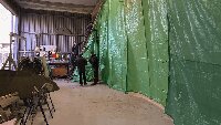 The volunteers preparing a spray-booth within the Stuart-Buttle hangar.
