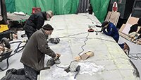 Dave Brocklehust MBE, David Hertz and Robbie Meads preparing the wing for painting.
