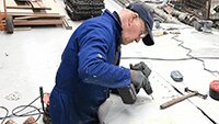 Robbie Meades utilising his some 50 years panel beating experience to start repairing the leading edge of the wing..