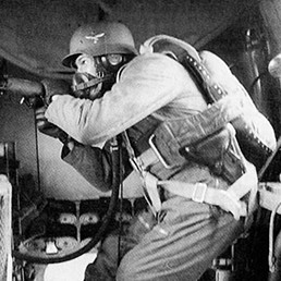 Heinkel side gunner wearing an oxygen mask. Heinkel side gunner wearing an oxygen mask.